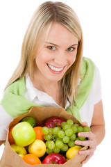 Healthy lifestyle - woman with fruit shopping paper bag