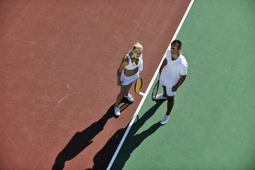 happy young couple play tennis game outdoor © .shock