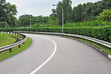 Curving Road Going Uphill With Crash Barriers
