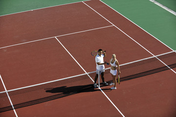 happy young couple play tennis game outdoor