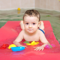 little happy boy swimming in pool