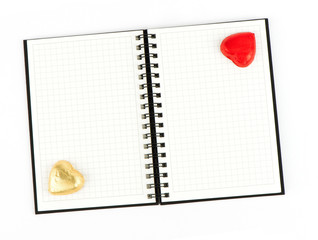 Open note book with chocolate hearts