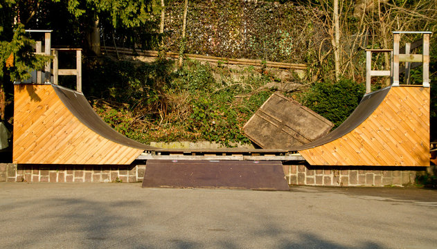 handmade wooden halfpipe in skatepark