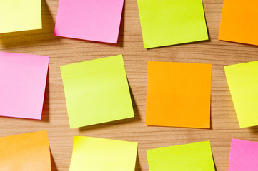 Many reminder notes on the wooden background