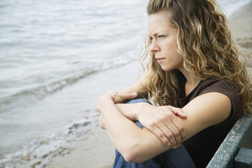Fototapeta na wymiar A Young Adult Woman Reflects On The Beach