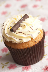 Cupcake topped with buttercream and chocolate