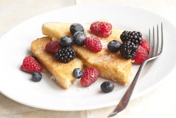French toasts with fresh berries on a plate
