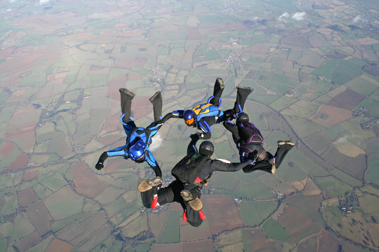 Four skydivers training