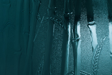 blue embossed bamboo leaves and stems on stained glass