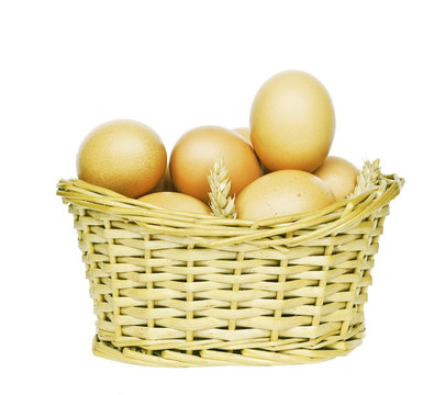 Eggs in wicker basket isolated on white