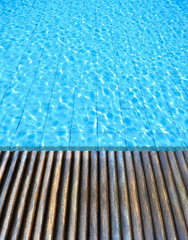 Obraz premium wood floor beside the blue swimming pool