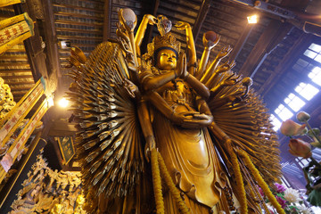 Buddhist thousand arms god statue