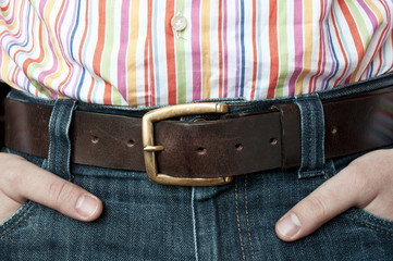 Jeans leather belt and shirt with hands in pocket