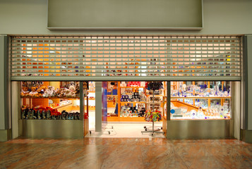 In front of souvenir shop with tableware and toys