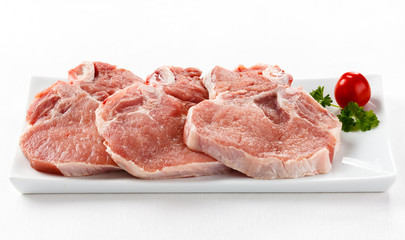 Fresh raw pork with bone on white plate