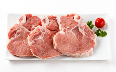 Fresh raw pork with bone on white plate