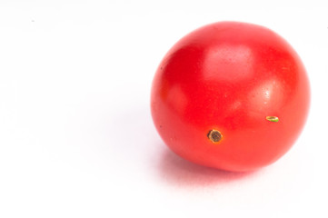 Single small red tomatoe on isolating background