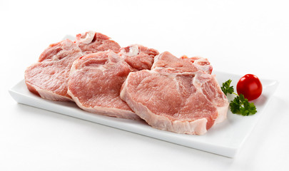 Fresh raw pork with bone on white plate