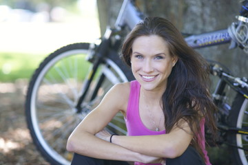 Fototapeta na wymiar Beautiful Woman Cyclist Rests