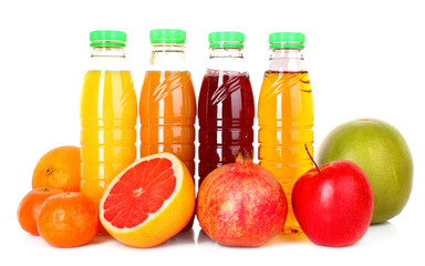 bottles of juice  with ripe fruits on white background
