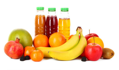 bottles of juice  with ripe fruits on white background