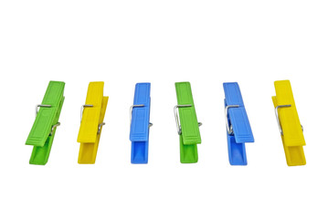 colored clothes-pegs on white background
