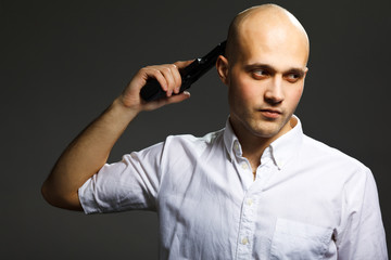 Portrait of a handsome young man holding a gun