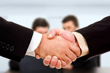 Close up of businessmen shaking hands at the office