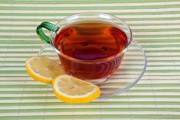 Tea with a lemon in a glass cup