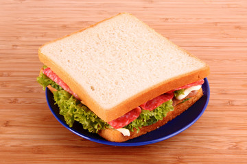 Sandwich on wooden plate