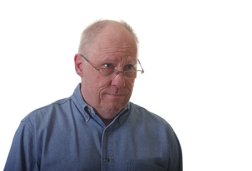 Obraz premium Older Man in Blue Denim Shirt with Confused Look