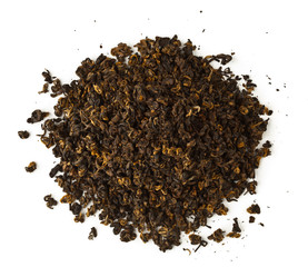 scattered pile of raw black tea isolated on white