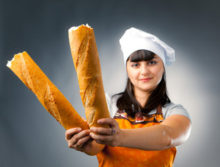 woman cook holding breaked french bread, focus on the bread