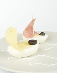 Obraz na płótnie Canvas egg boats sailing on a plate