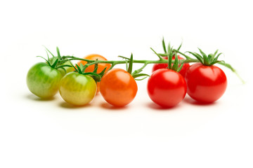 green and red cherry tomatoes isolated on white
