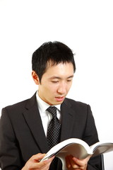 japanese businessman reads a book