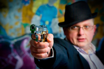 Fototapeta premium man aiming with gun. Close-up shot on gun