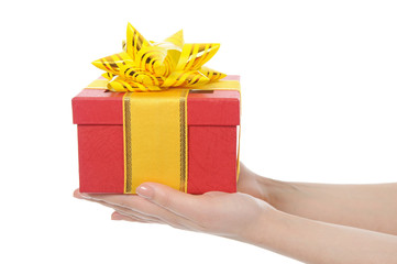 Box with a gift in the hands of women
