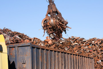 Crane grabber loading a Truck with metal scrap