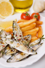 Grilled sardine fish and french fries