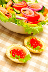 vegetable salad and tartlets with caviar