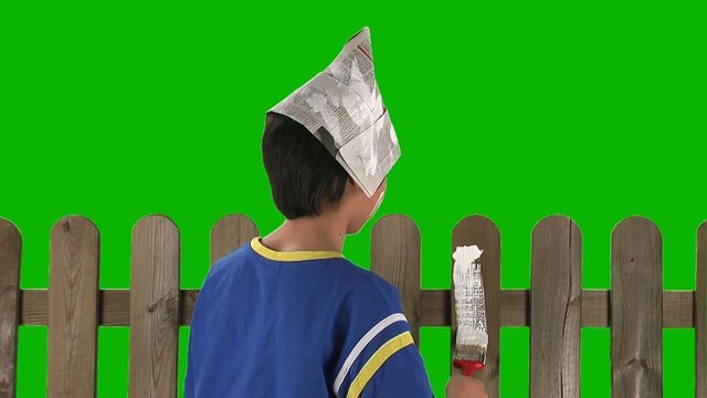 boy painting wooden fence