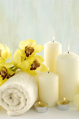 Fototapeta na wymiar Spa composition (white towel and yellow orchids on towel)