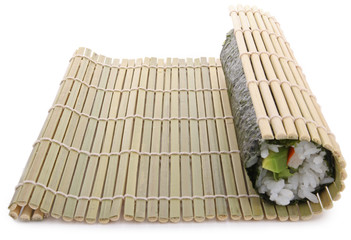 rolling sushi maki on white background © M.studio