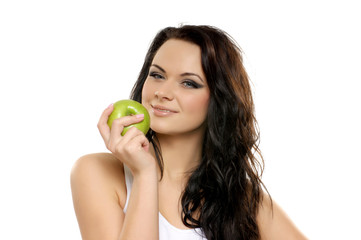 Obraz na płótnie Canvas Portrait of a young brunette holding a fresh green apple