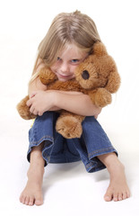 Girl with shy expression with her teddy bear.