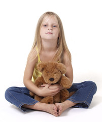 Girl with teddy bear with a neutral expression