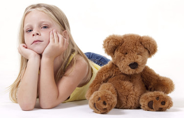 Young girl lying with her face in her hands