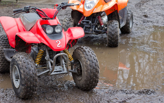 Two quad bikes ready for action in the mud