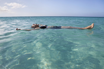 Woman floating and relaxing in the sea